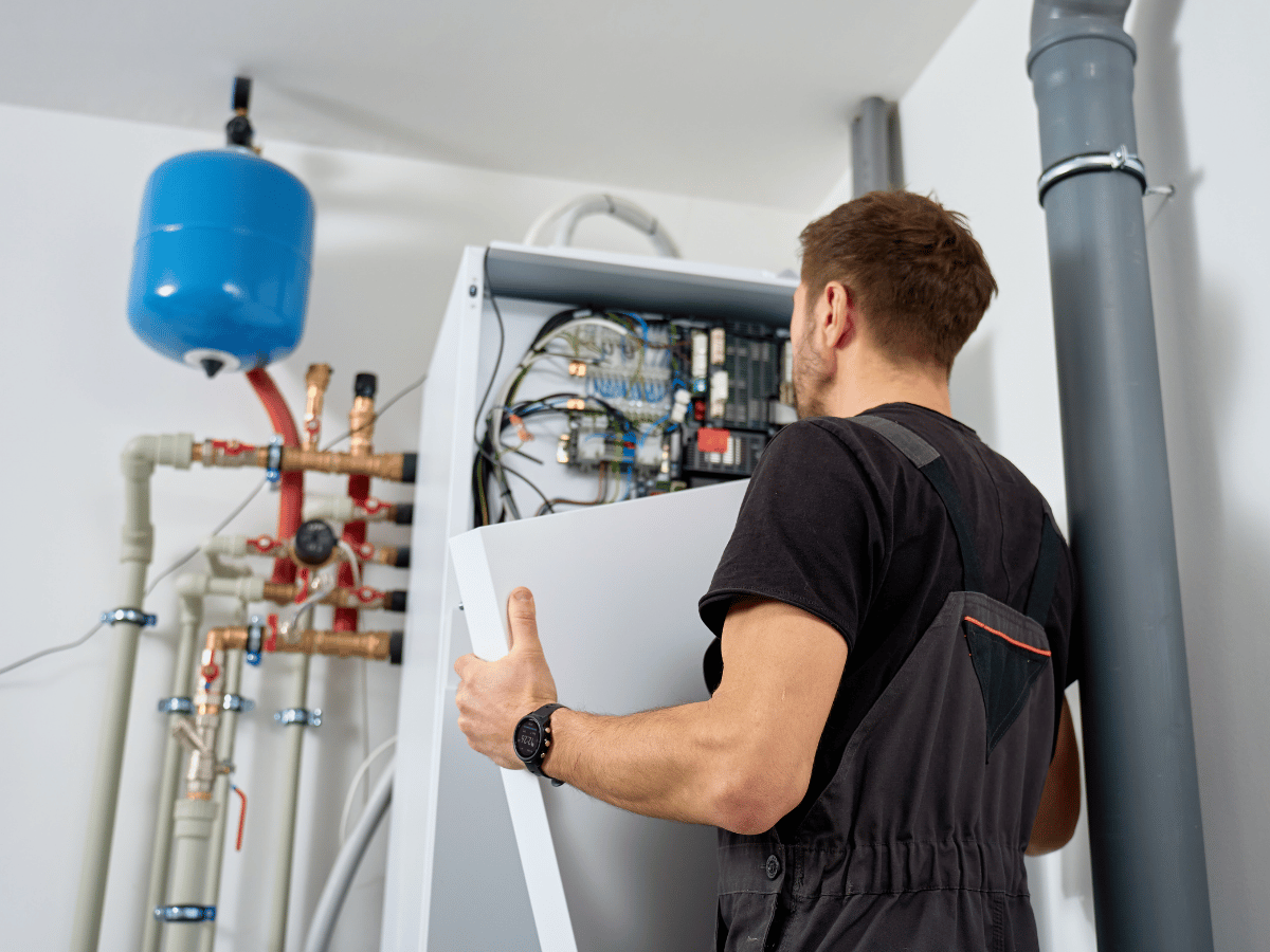HVAC technician installing and configuring a residential heat pump system in Powhatan, VA