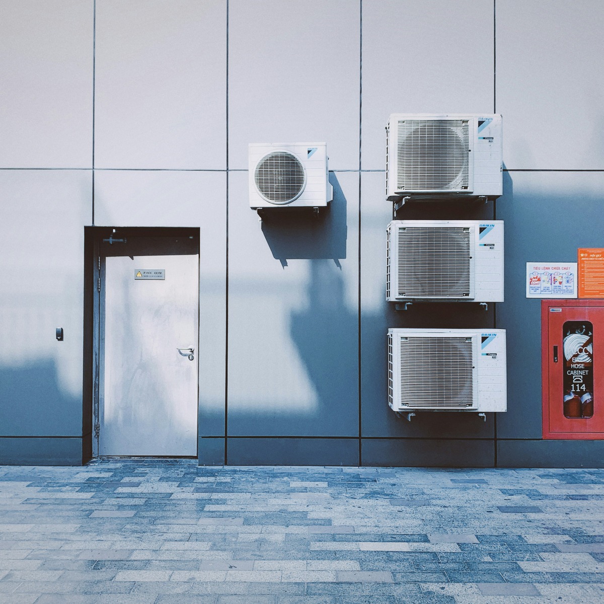 Multiple outdoor HVAC condenser units installed on a commercial building, showcasing trusted AC Installation & Replacement throughout Virginia's Independent Cities
